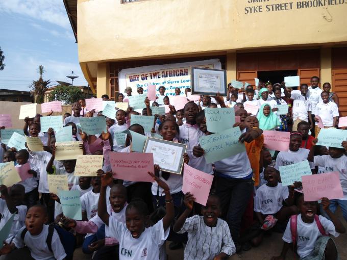 Children holding messages during the commemoration of the Day of the  African Child 